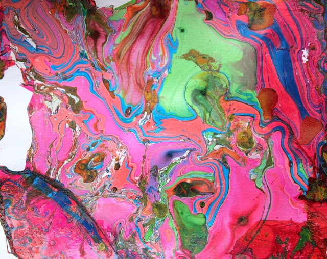 Marble painting with enamel paint poured onto the surface of water.