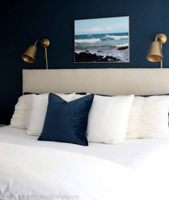 Navy and white primary bedroom with layers for fall.