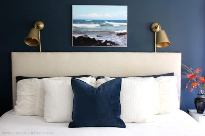 A cozy navy and white master bedroom.