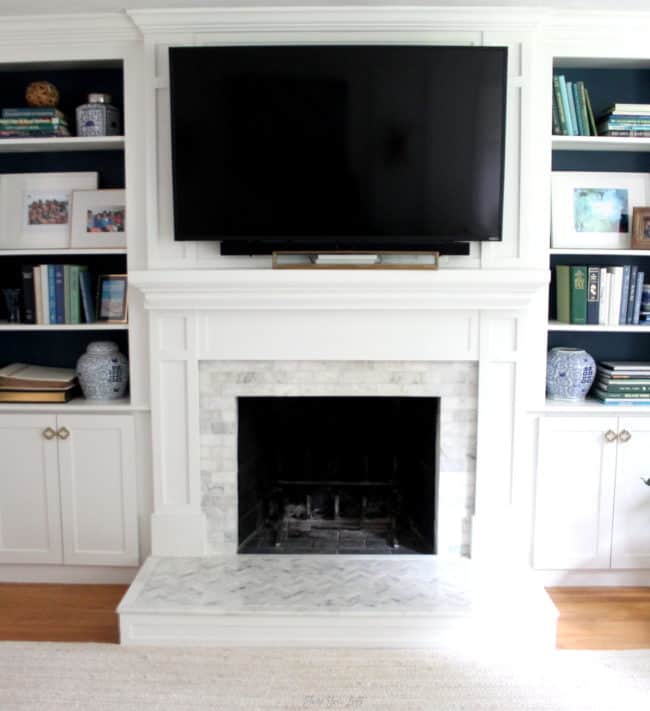 Styling fireplace bookcases with a color palette of blues, greens and white with a few natural elements.