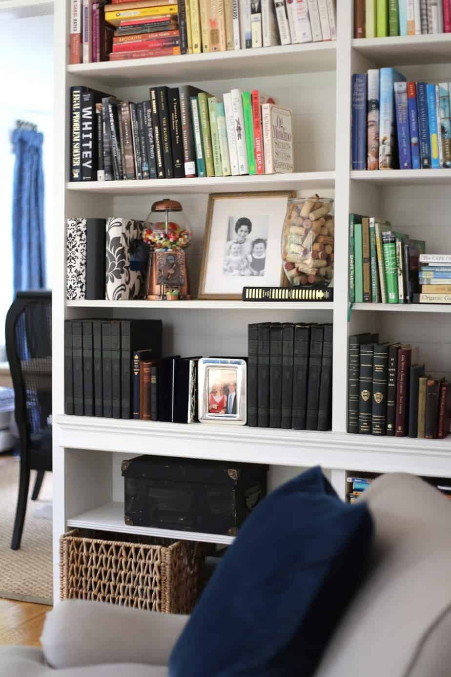 Built in bookcases with old and new books and black and white photos.